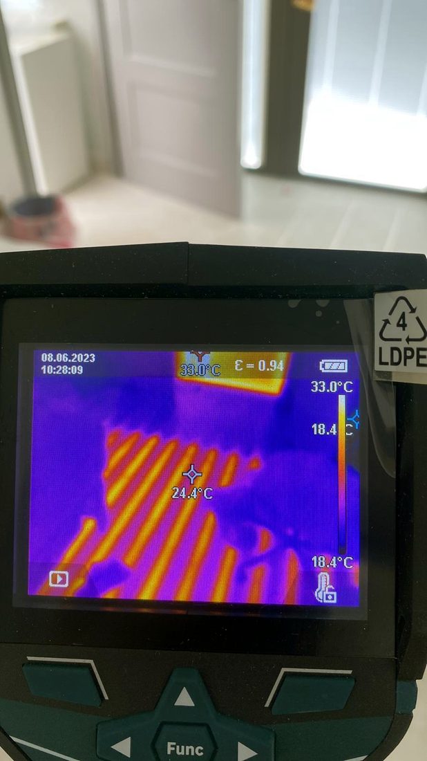 Thermal imaging camera showing heat across underfloor heating pipes